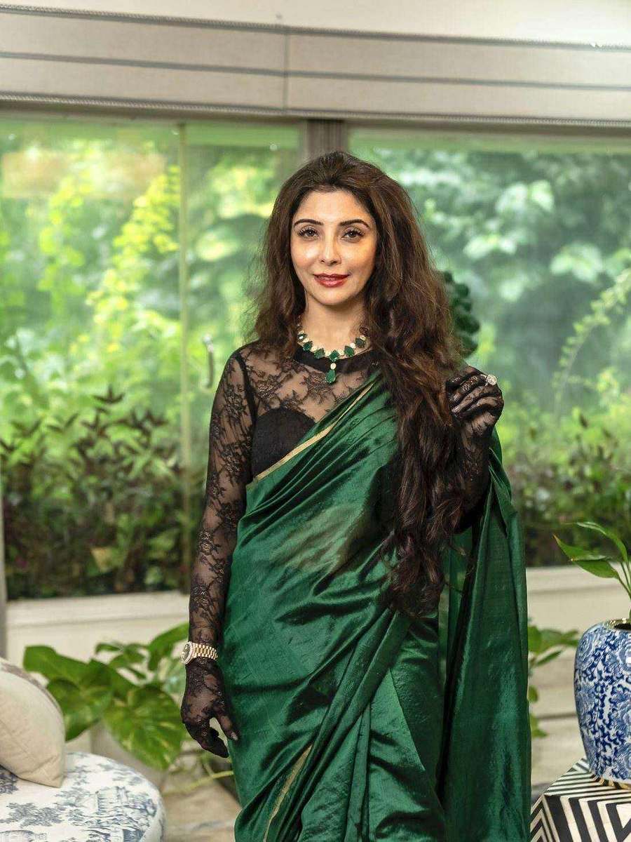 A deep green sari with a black lace blouse