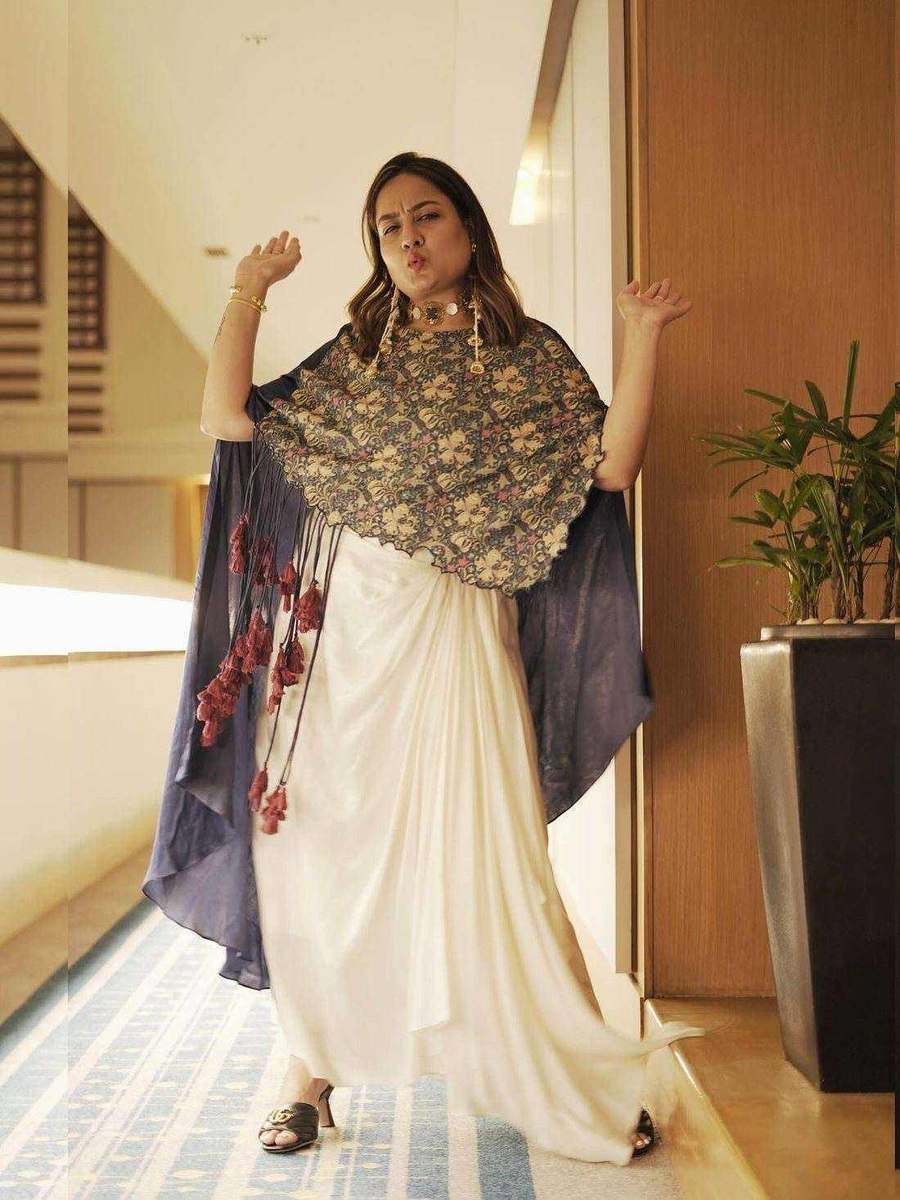 An ivory drape gown with an embellished cape