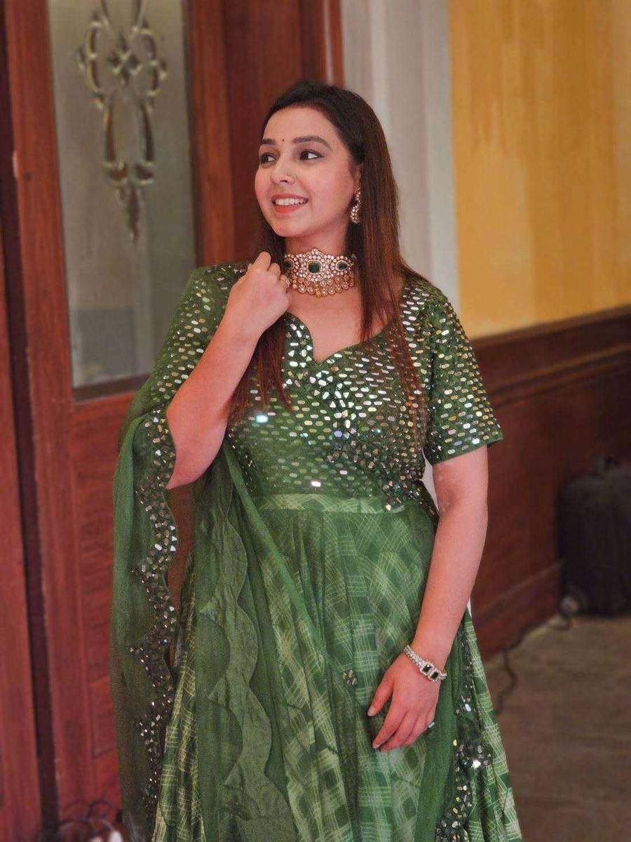A green mirror-work lehenga at a wedding function