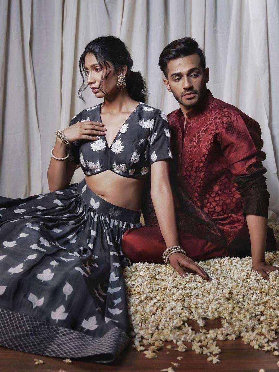 Two clients of Tanya Jain styled together, in a monochrome floral lehenga and a red kurta